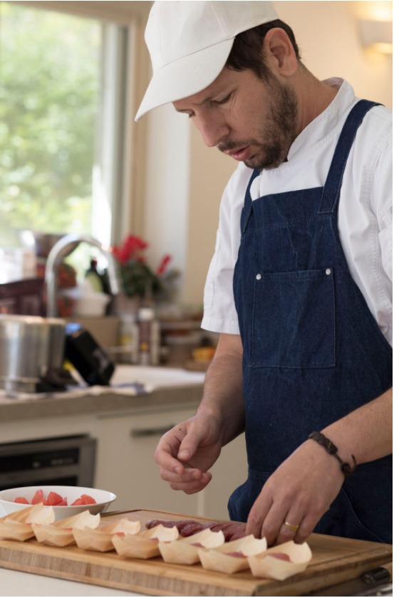 Chef Dan plating canapés in a residential kitchen
