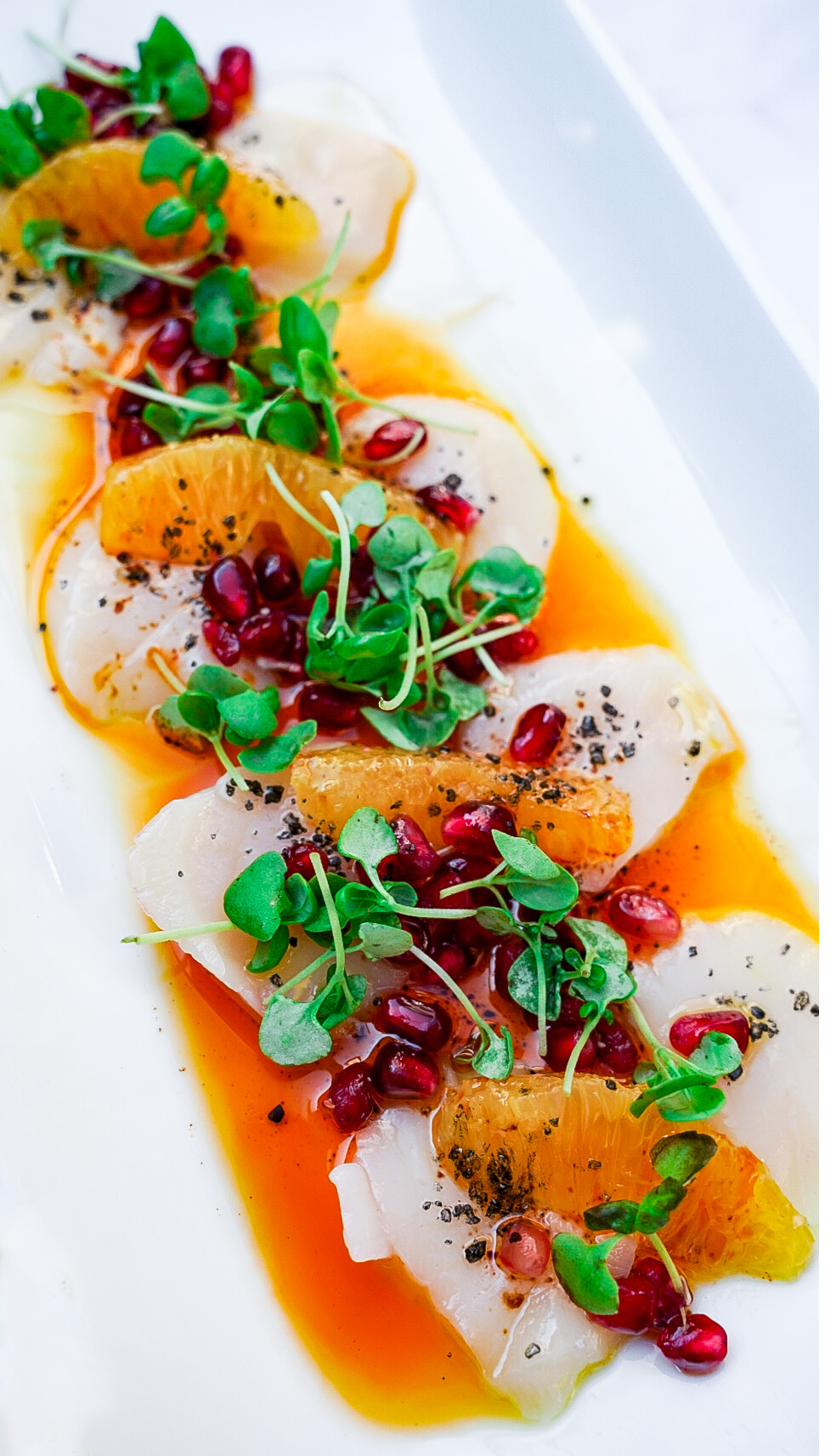 Scallop crudo with citrus, pomegranate and microgreens