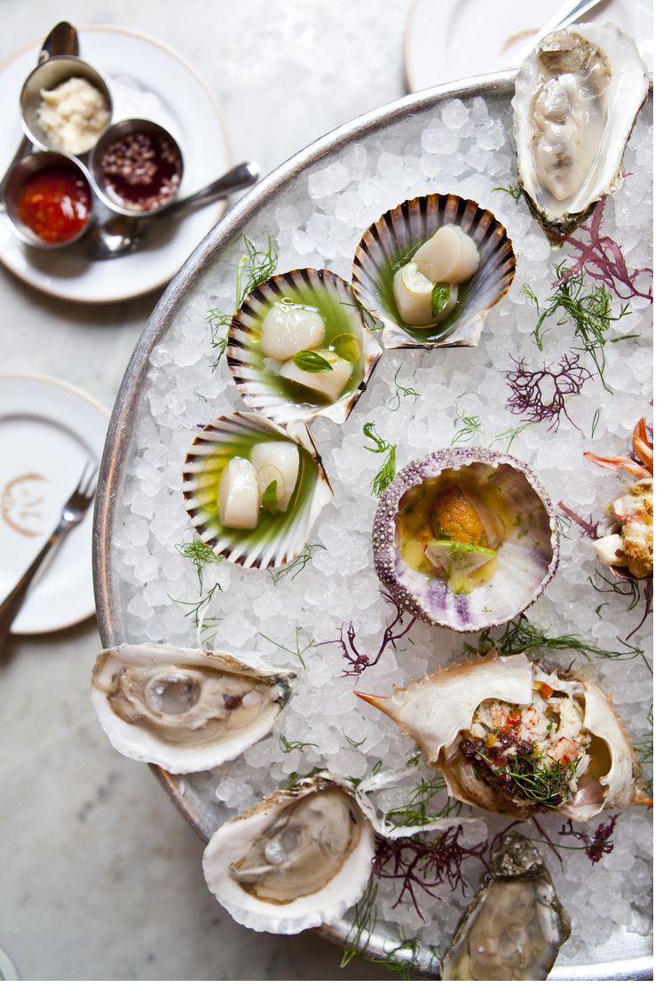 Raw bar with oysters, scallops, uni and crab on crushed ice